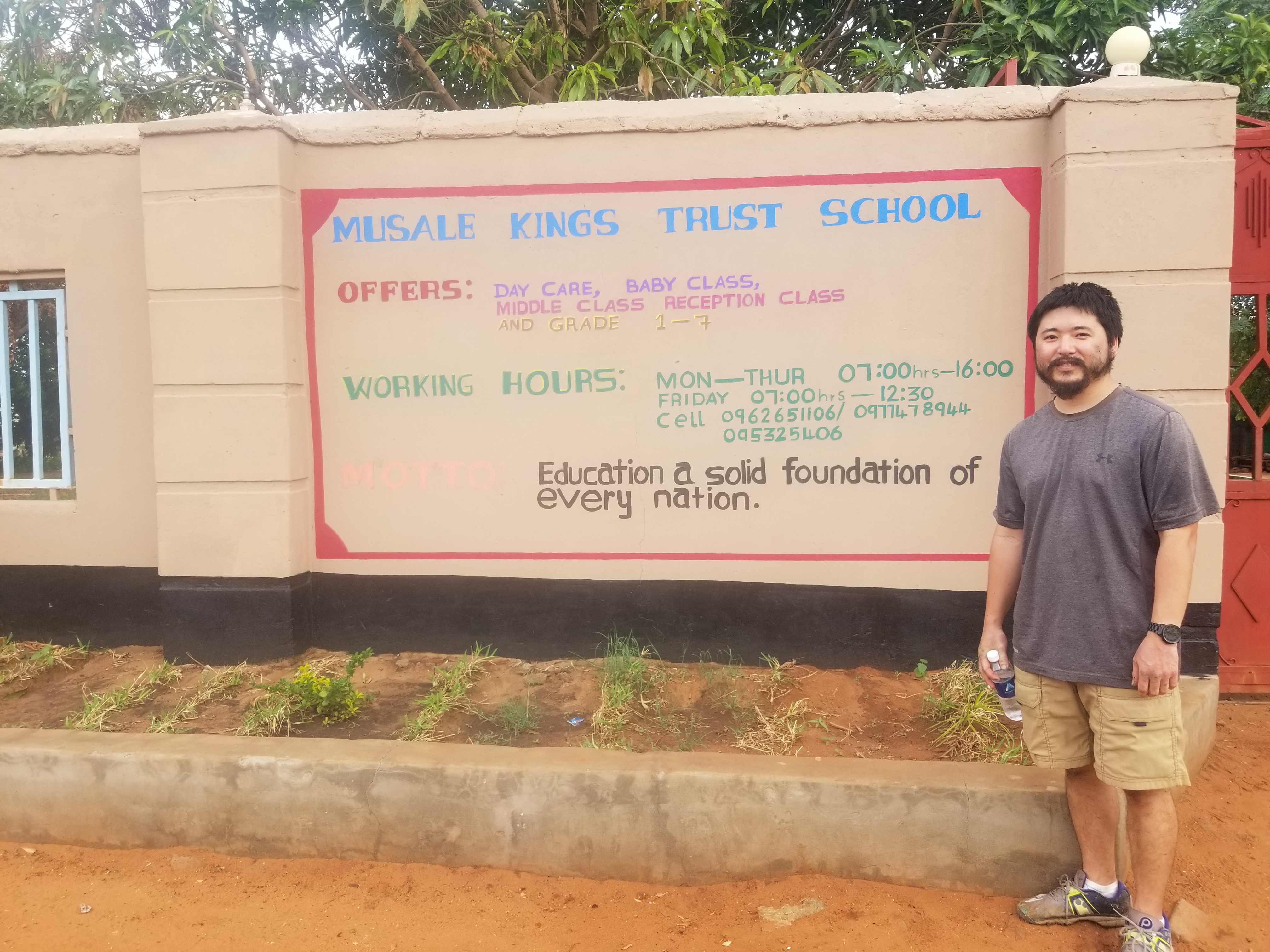 Ken Kajihiro outside of one of the new schools.